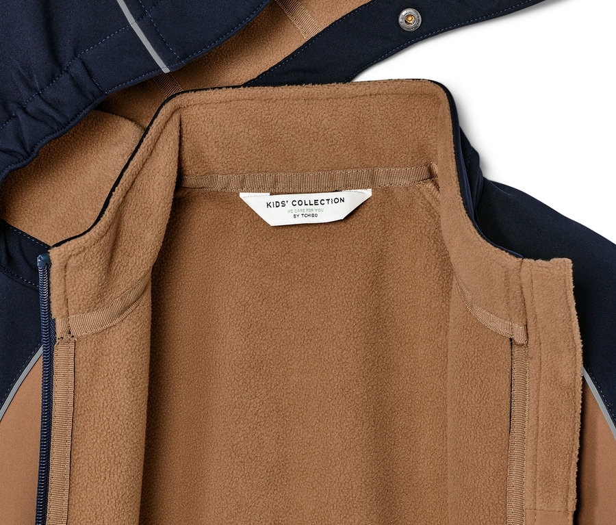 Detailansicht einer Kinder-Softshelljacke mit braunem Fleecefutter.