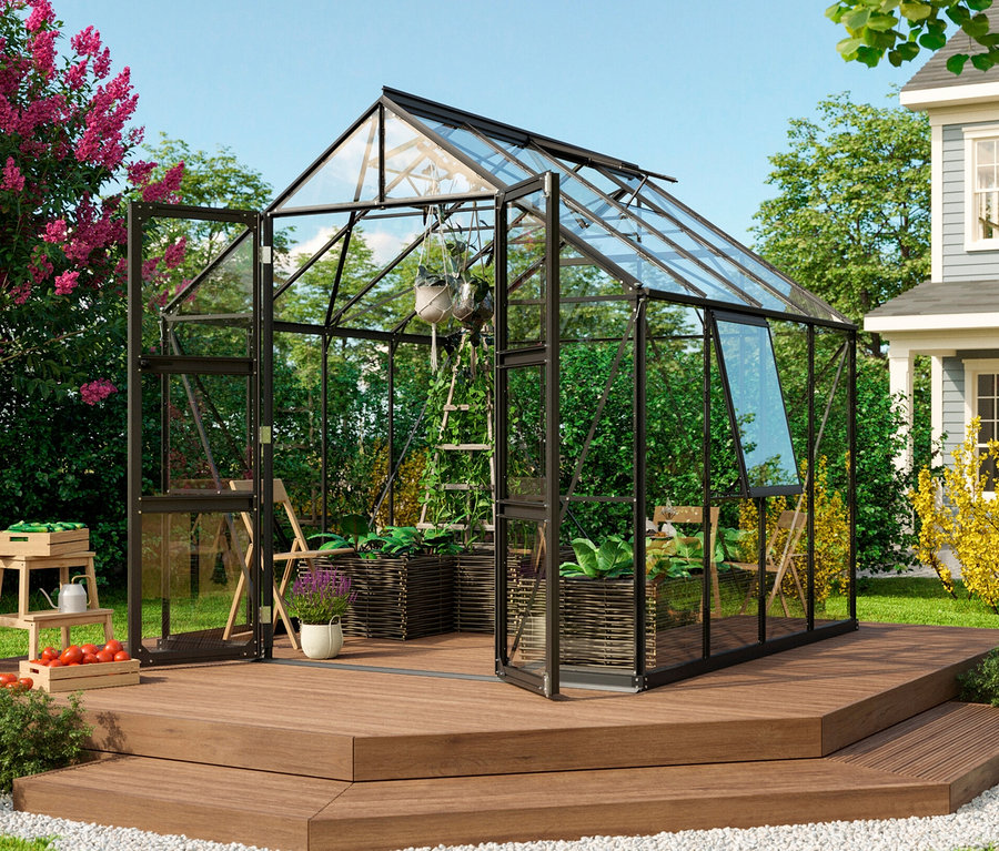 Vitavia Gewächshaus Olymp 6,7m² inkl. Fundamentrahmen steht auf einer Holzterrasse neben einem Haus.