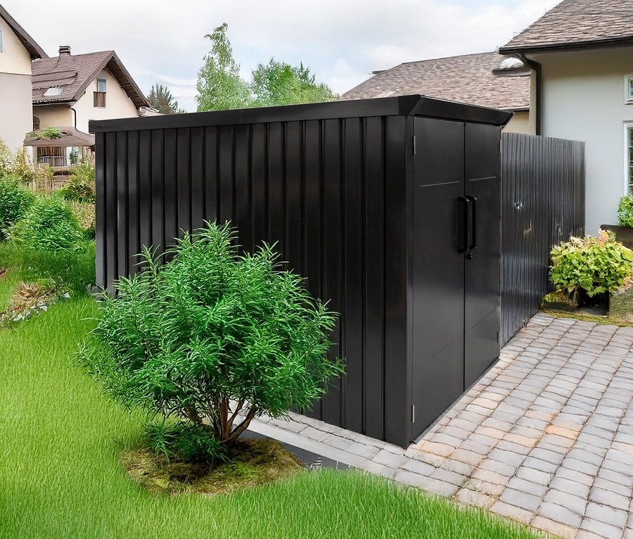 Eine schwarze Fahrradbox steht auf einem gepflasterten Weg neben einem grünen Rasen.