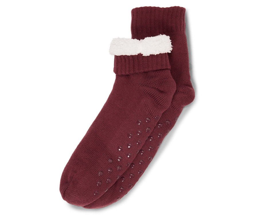 Zwei burgunderrote Socken mit rutschfester Sohle und weißem Rand.