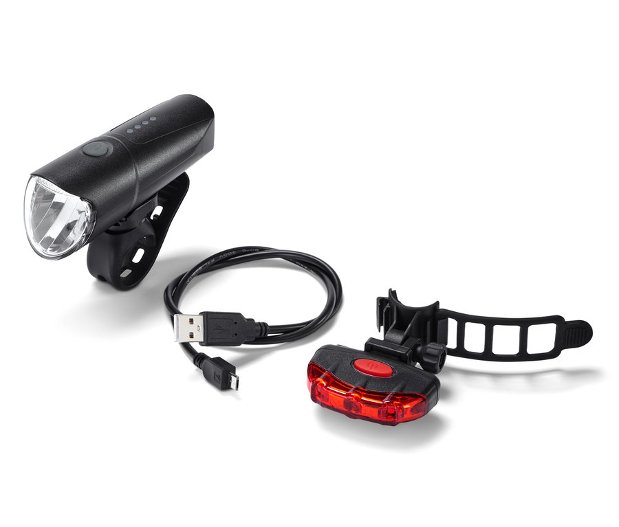 Schwarzes Fahrrad-Beleuchtungs-Set mit USB-Kabel auf weißem Hintergrund.