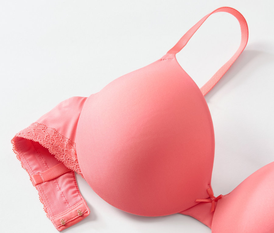 Detailaufnahme von T-Shirt-BH in Papaya-Farbe auf weißem Hintergrund.