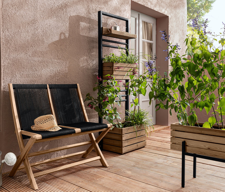 Eine klappbare Gartenbank mit Textilgeflecht, eine Pflanzwand »Elin« und ein Pflanzkasten »Elin« mit Pflanzen auf einer Terrasse.