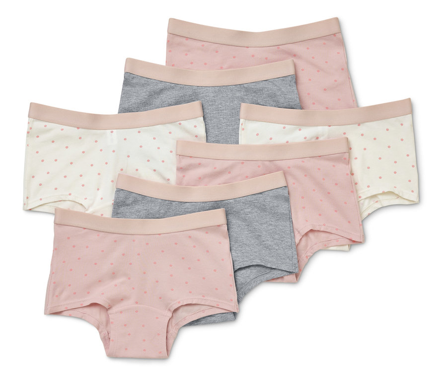 Sieben kurze Damenslips in den Farben Rosa, Grau und Weiß mit zarten Punkten liegen übereinander.