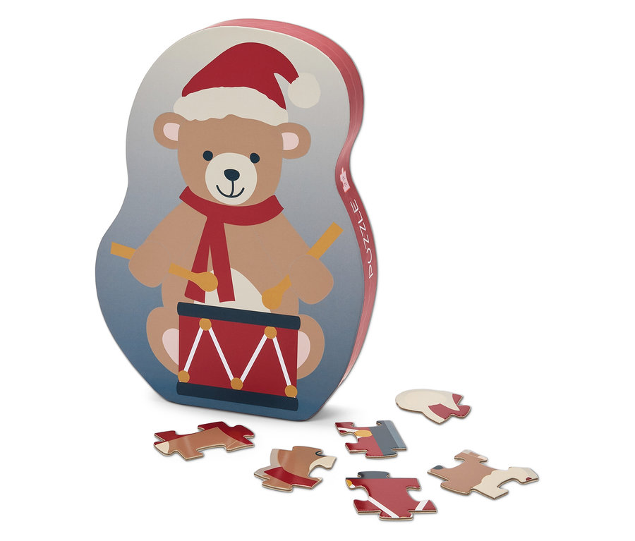 Puzzlebox mit Bär, der eine Trommel in Weihnachtsmannmütze spielt, und sechs Puzzleteilen.