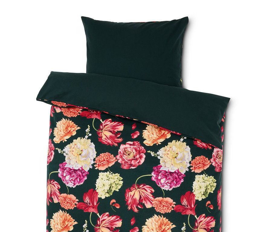 Grüne Bettwäsche mit Blumenmuster.
