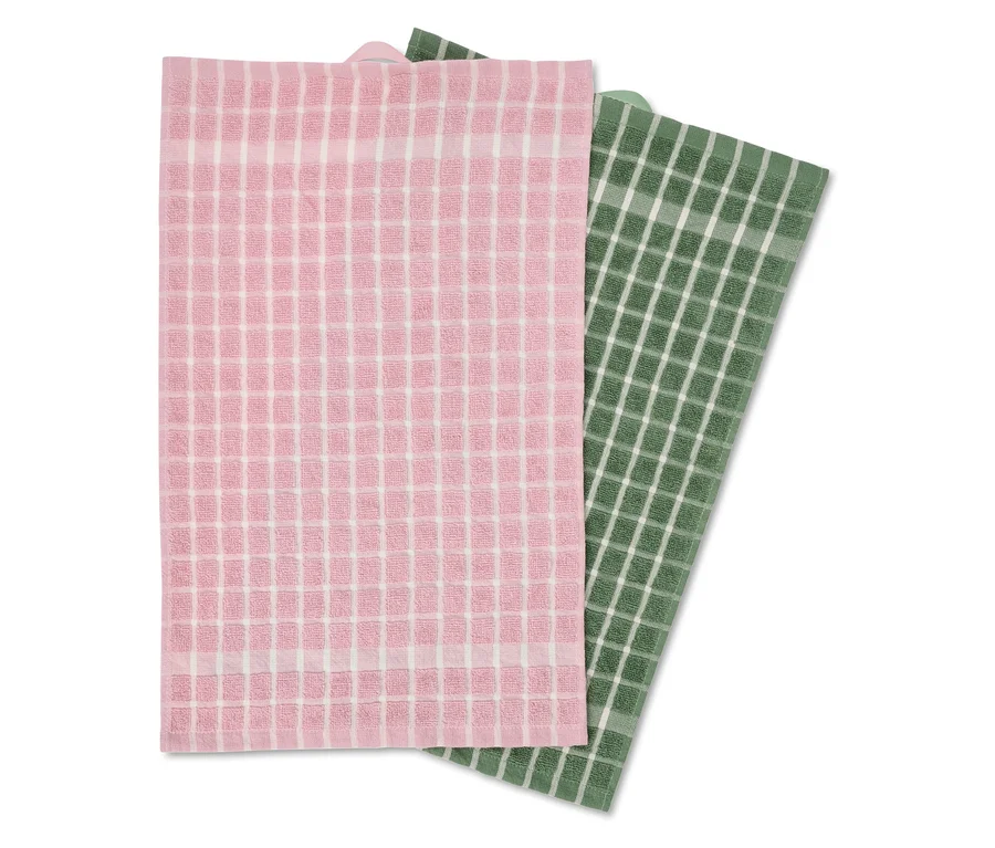 Ein rosa und ein grünes Geschirrtuch mit weißem Karomuster liegen übereinander.