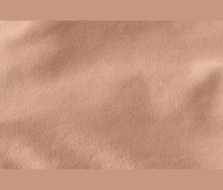 Helles, beiges Stoffgewebe mit feiner Textur und leichten Falten.