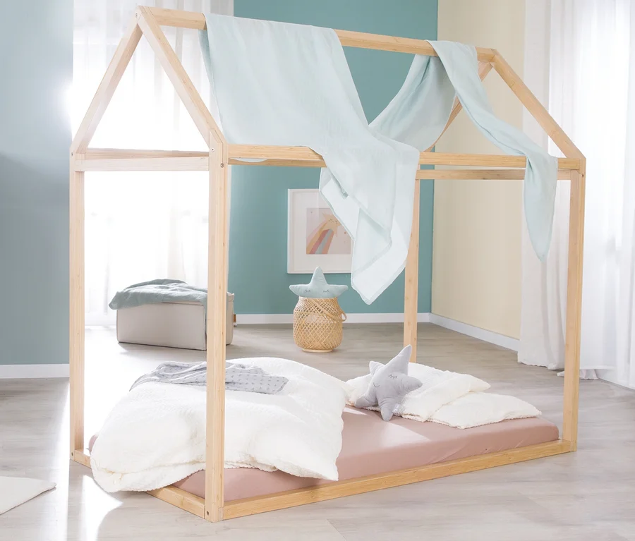 Ein roba Hausbett, ca. 70 x 140 cm, in Bambusoptik mit Himmel und sternförmigen Kissen.