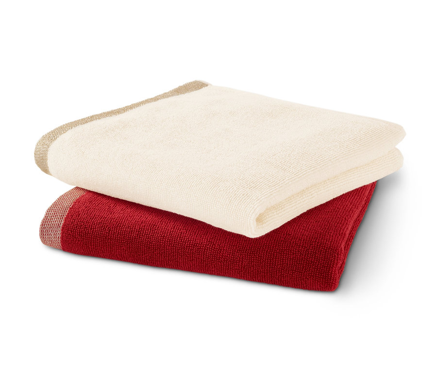 Zwei Frottier-Küchenhandtücher, ein rotes und ein cremefarbenes, liegen übereinander.
