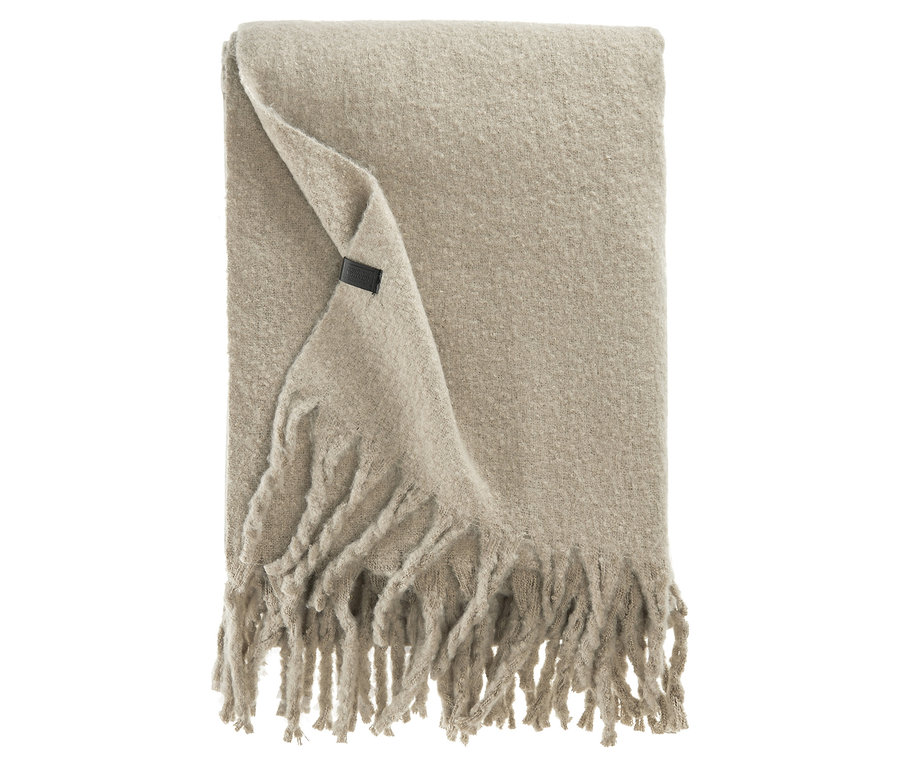 Beige Decke mit Fransen und Etikett.