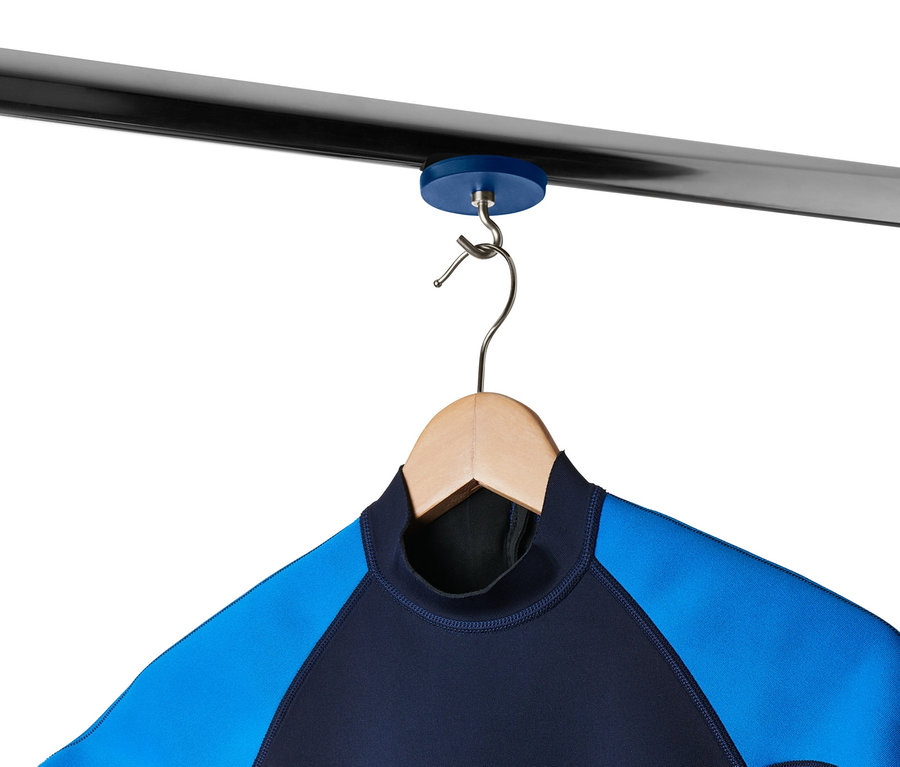 Blau-schwarzer Neoprenanzug hängt an einem Holzbügel, der an 2 extrastarken Magnethaken an einer Metallstange hängt.