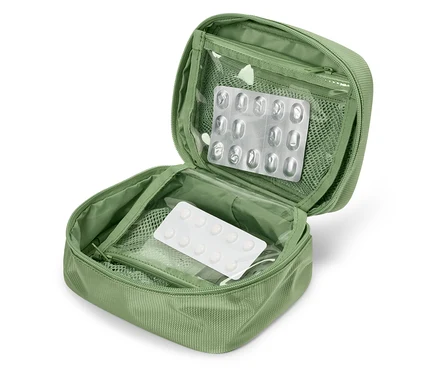 Offener grüner Erste-Hilfe-Kasten mit Blisterpackungen mit Medikamenten darin.