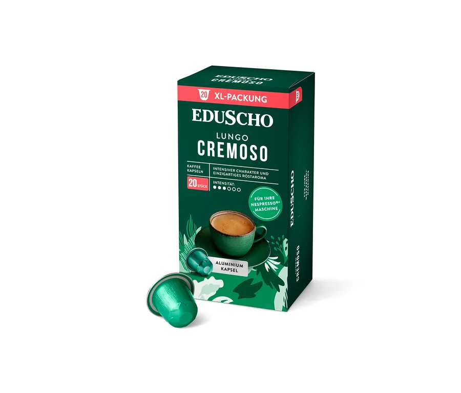 Eine grüne Packung EDUSCHO Lungo Cremoso Kaffeekapseln steht neben einer einzelnen Kapsel.