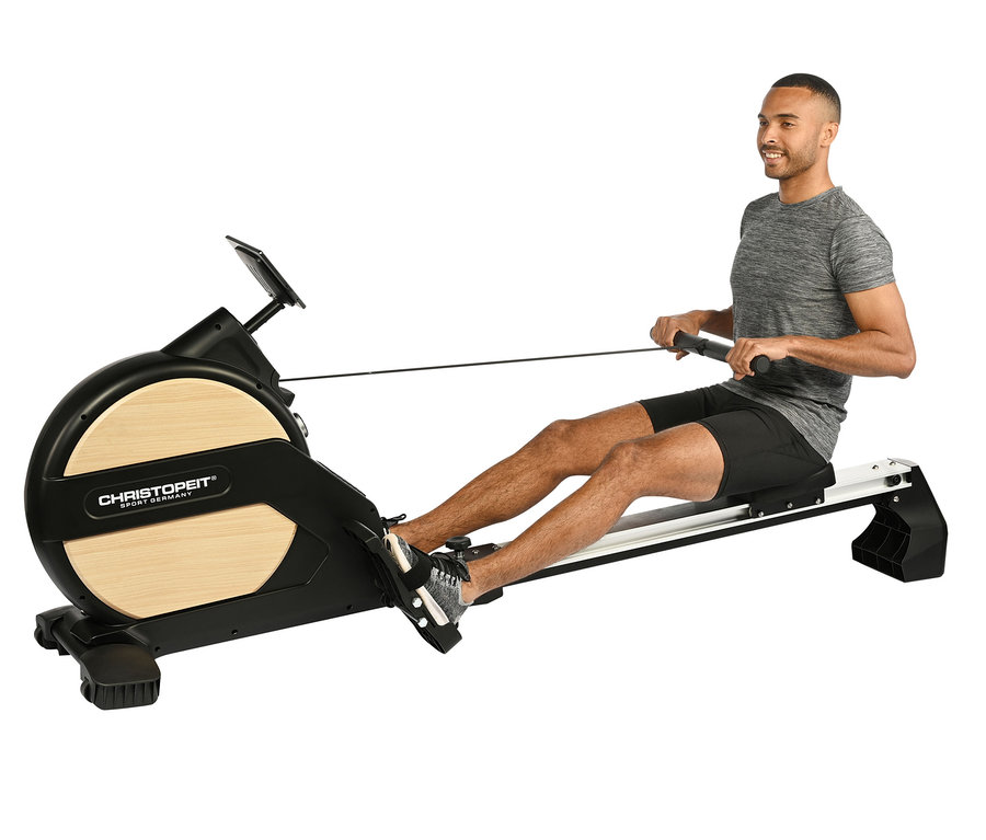 Mann trainiert auf Rudergerät »Ergometer Vico«.