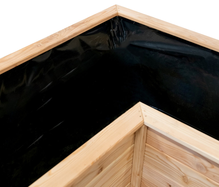 Detailaufnahme einer Ecke des L-förmigen Hochbeets aus Lärchenholz mit schwarzer Auskleidung.