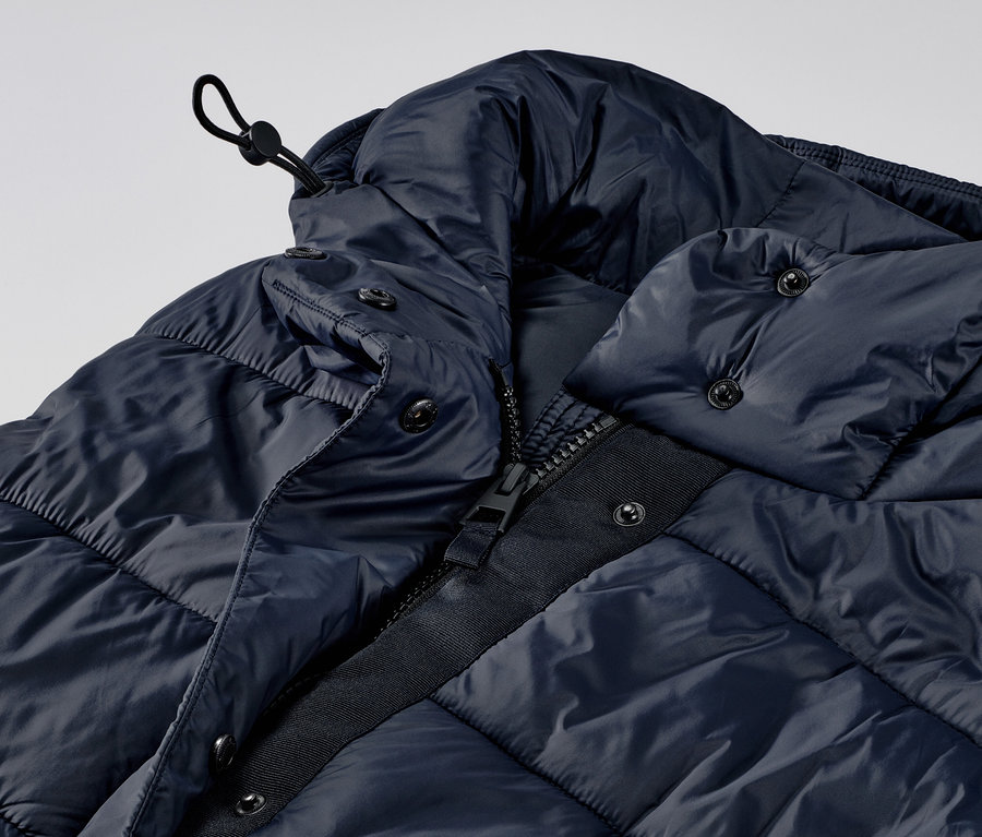 Detailansicht einer langen Steppweste mit Kapuze.