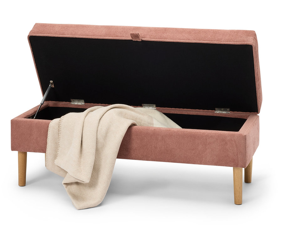 Offene rosafarbene Aufbewahrungsbank mit einer beige Decke darin.