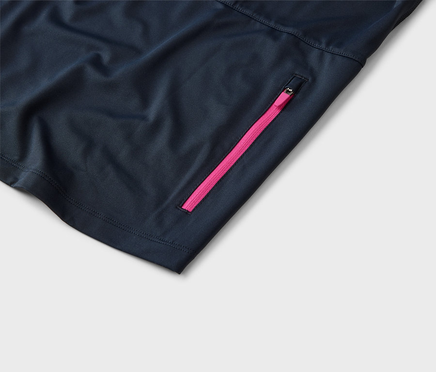 Nahaufnahme eines dunkelblauen Stoffes mit einem pinkfarbenen Reißverschluss.