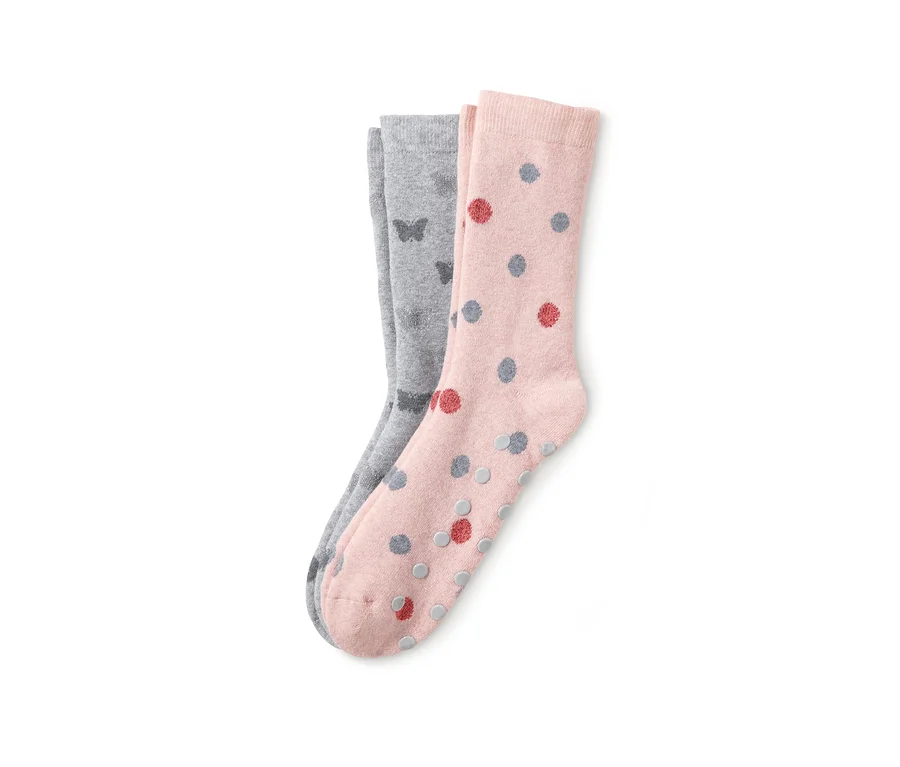 Zwei Paar Damen-Stoppersocken: ein Paar rosa mit bunten Punkten, das andere grau mit Schmetterlingen.