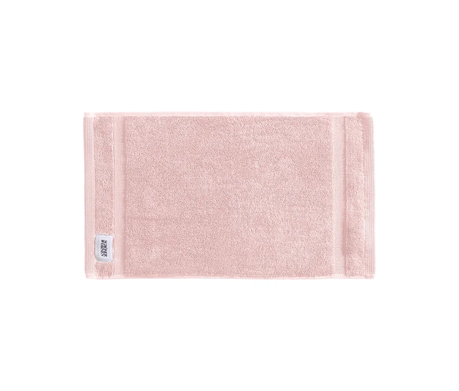 Rosa Gästehandtuch der SCHÖNER WOHNEN-Kollektion „Cuddly“ mit Etikett in der unteren linken Ecke.