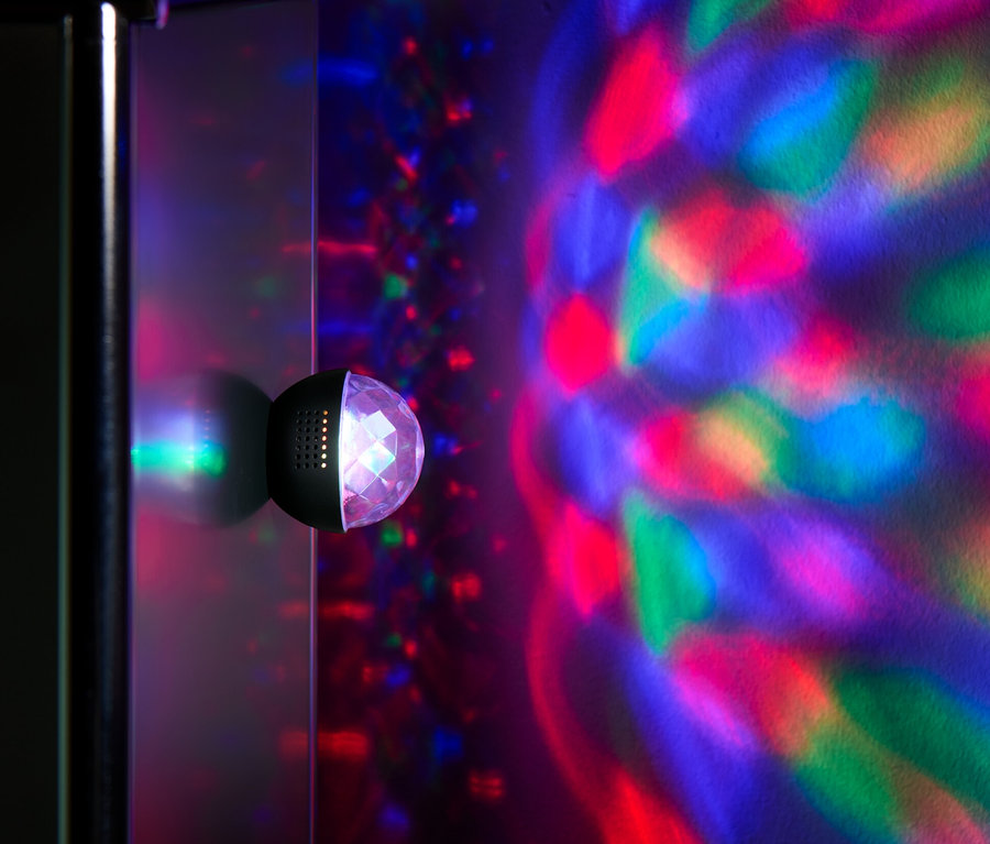 Eine Mini-Discokugel an der Wand wirft bunte Lichter an die Wand.