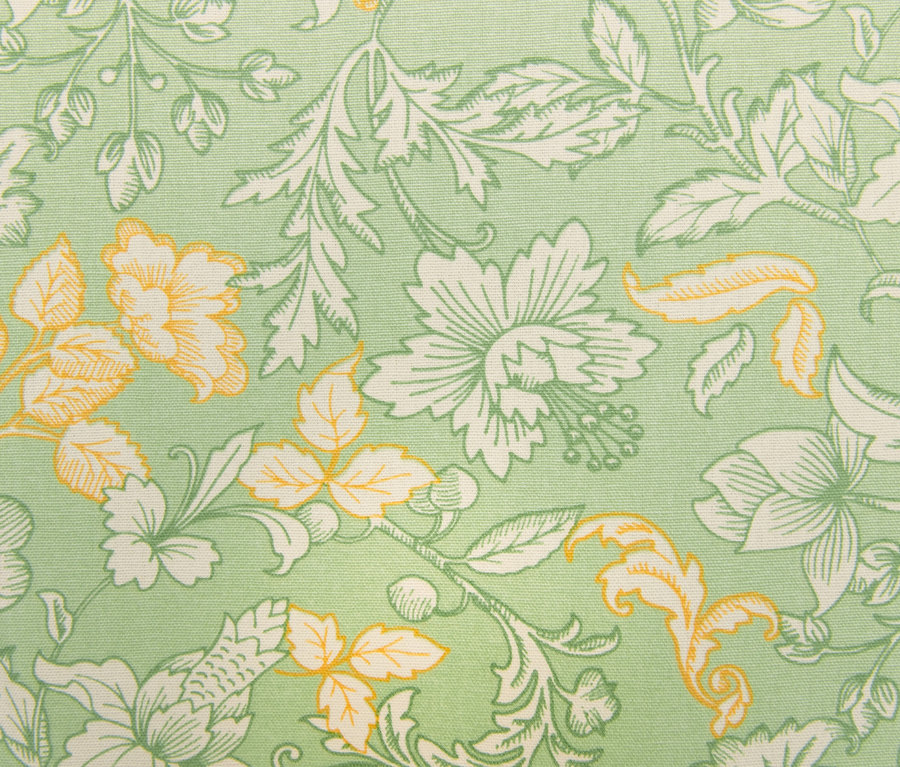 Nahaufnahme einer grünen Tischdecke mit Blumenmuster.