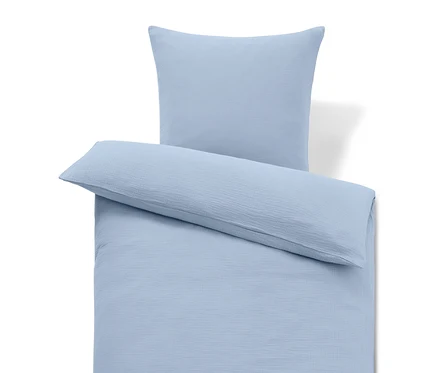 Hellblaue Bettwäsche mit Kissen und langem Kissen.