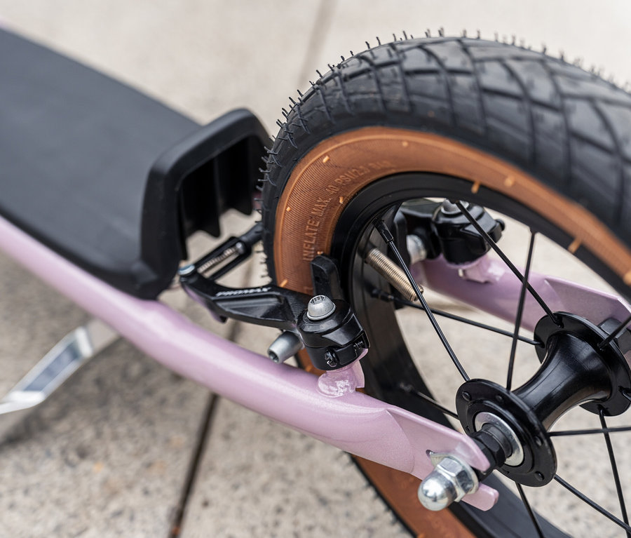 Detailaufnahme eines Puky Scooter R 07 L, pearl pink, Fokus auf Hinterrad, Bremse und Trittbrett.