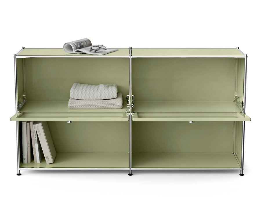 Grüner modularer Schrank mit Büchern, Decke, Brille und Zeitung.