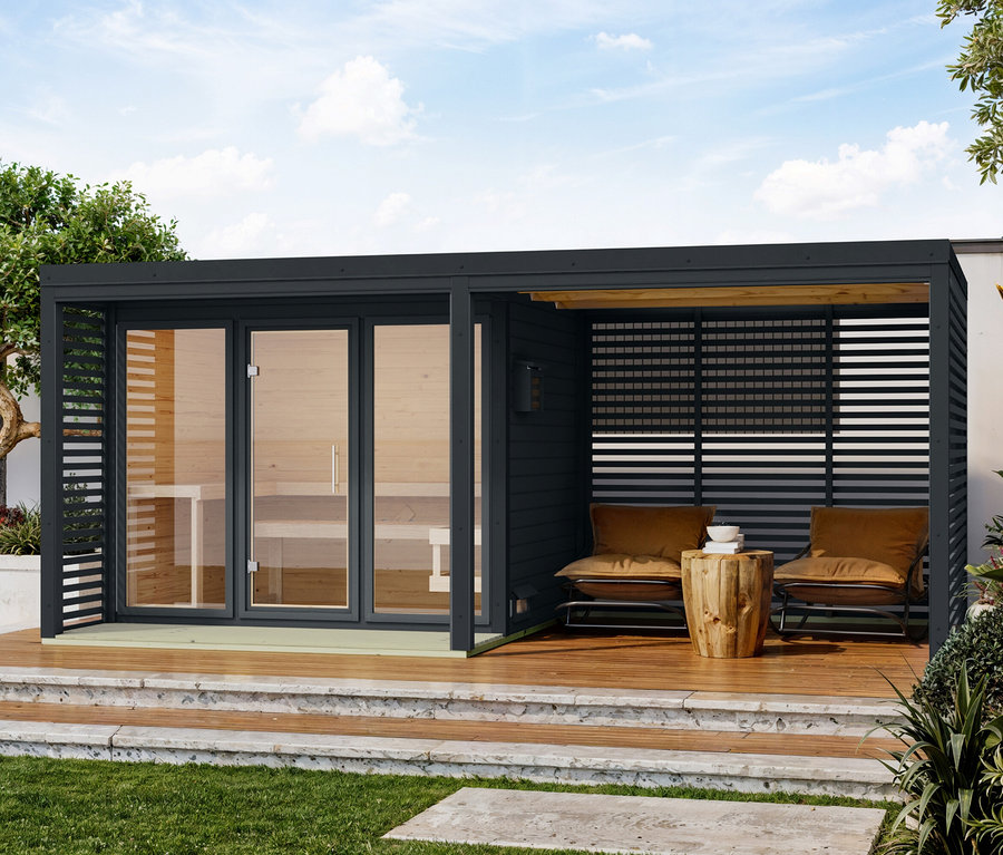 Schwarze Pergola mit Sauna und Sitzbereich mit zwei Sesseln auf einer Holzterrasse.