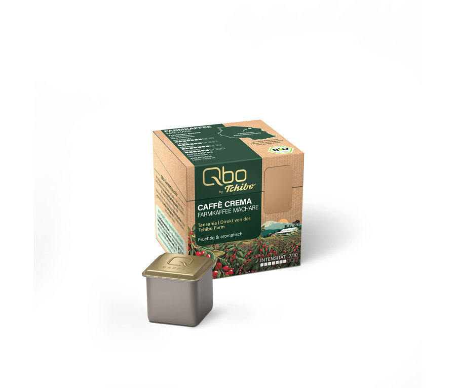 Braune und grüne Verpackung für Qbo Caffè Crema Farmkaffee Machare Kapseln mit einer einzelnen grauen Kapsel daneben.