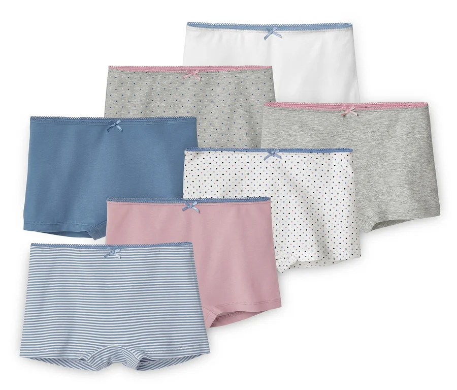Sieben Mädchen-Pantys in verschiedenen Farben und Mustern, darunter Streifen und Punkte.