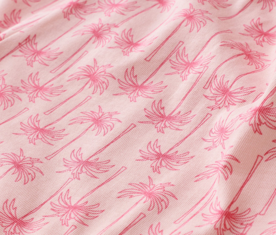 Nahaufnahme von rosa Stoff mit Palmenmuster.