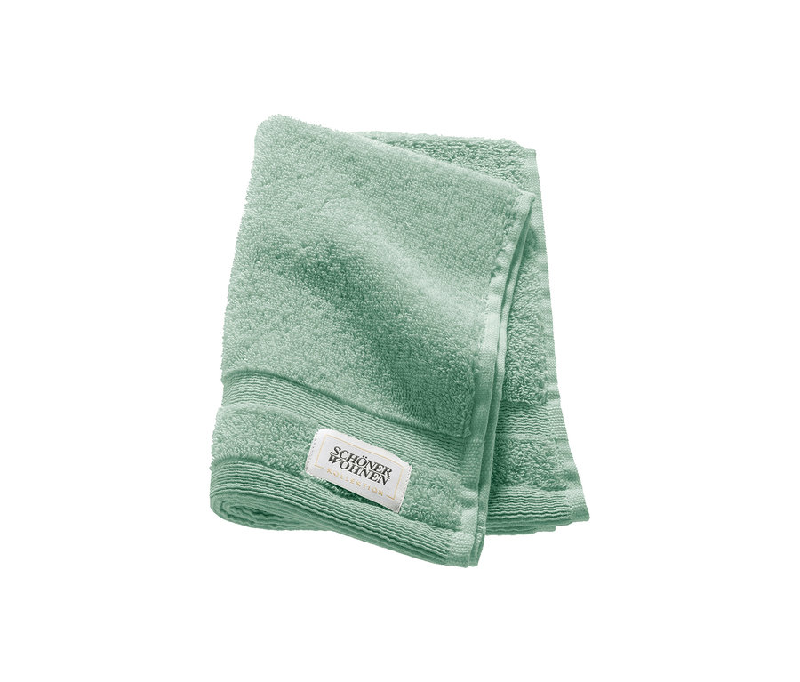 Ein gefaltetes salbeigrünes Gästehandtuch der SCHÖNER WOHNEN-Kollektion „Cuddly“.