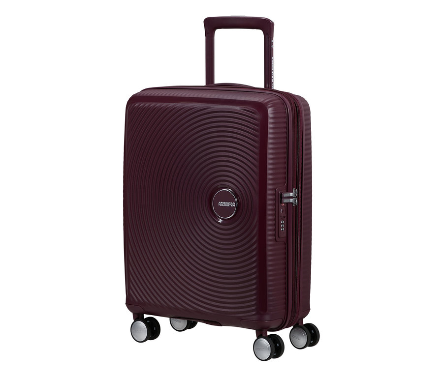American Tourister Hartschalen-Koffer Soundbox Spinner in Wildkirschrot mit konzentrischen Kreisen und ausziehbarem Griff.