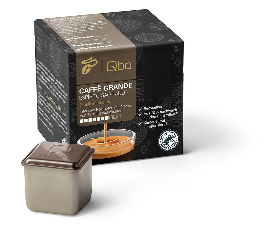Eine Packung Qbo Caffè Grande ESPÍRITO SÃO PAULO und eine Kapsel sind zu sehen. Die Beschriftungen auf der Packung sind auf Deutsch.