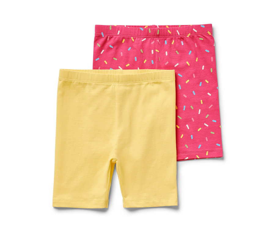 Zwei Kinder-Radler-Leggings, eine pink und eine gelb.