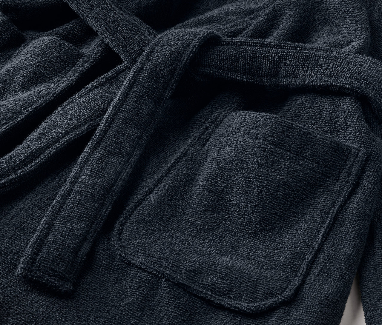 Detailansicht eines Kinder-Bademantels mit Tasche und Gürtel.