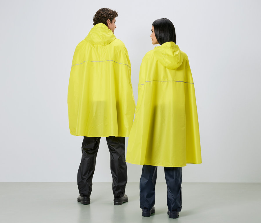 Rückansicht von zwei Personen mit Kapuze in gelben Regenponchos mit reflektierenden Streifen und dunklen Regenhosen vor weißem Hintergrund.
