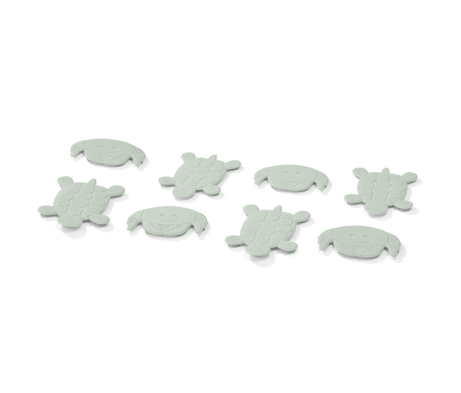 Acht hellgrüne Antirutsch-Pads in Form von Krabben und Schildkröten.