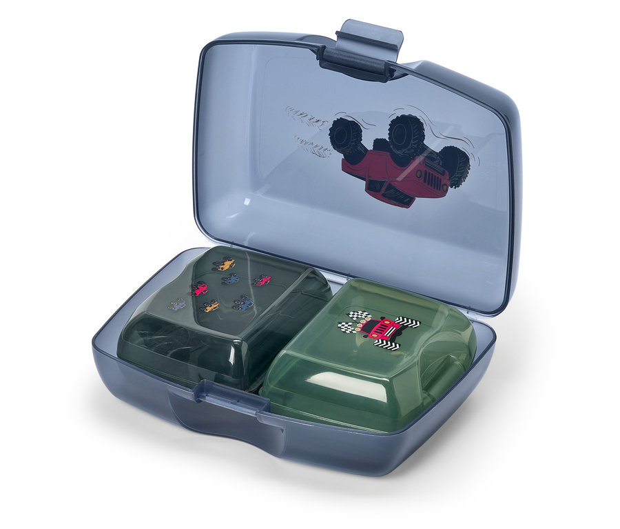 Eine offene blaue Brotdose mit zwei kleineren Behältern darin. Der Deckel ist mit einem roten Auto bedruckt.