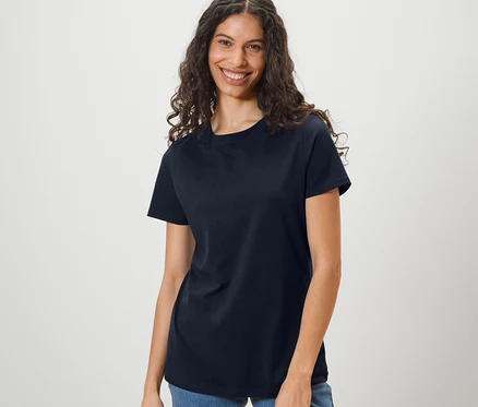 Frau trägt ein dunkelblaues Basic T-Shirt und Jeans.