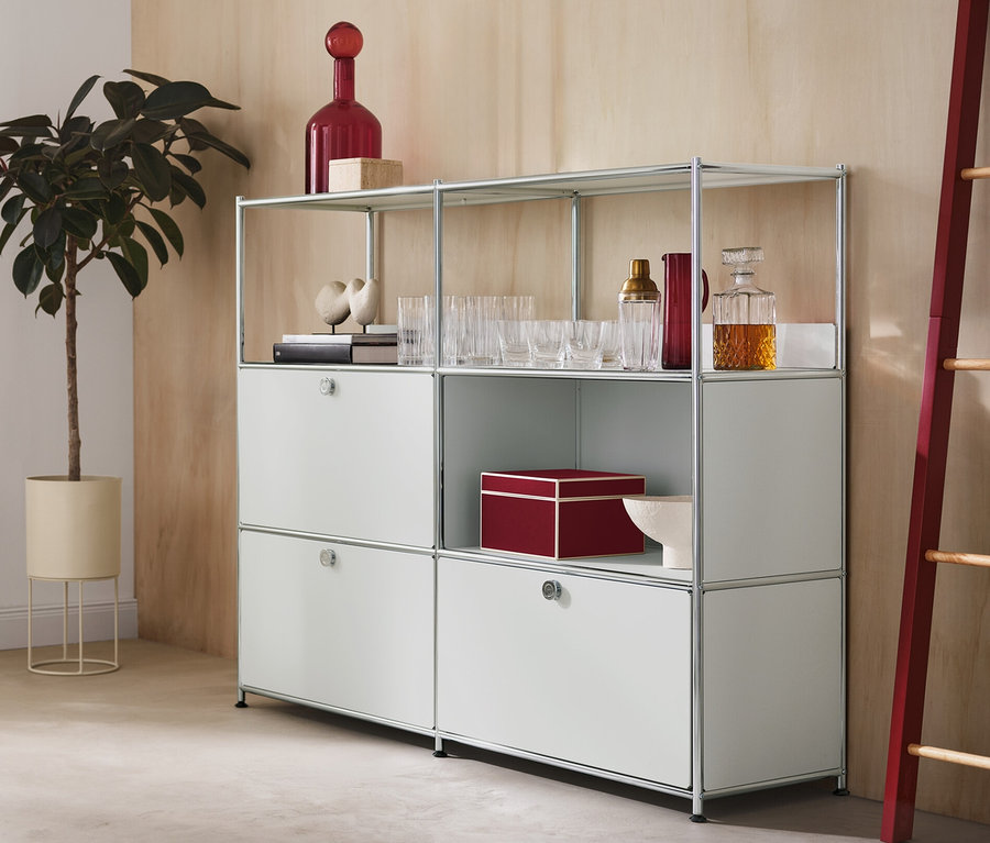 Im Zimmer stehen eine runde Pflanzbox mit einer Pflanze, eine Kommode Metall »CN3« mit 2 Klappen und 1 Schublade und eine Dekoleiter mit roten Seitenelementen.