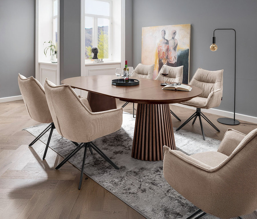 Esstisch mit sechs DeVries Diningsessel »Ginosa« in Beige. Auf dem Tisch stehen Getränke und ein offenes Buch.