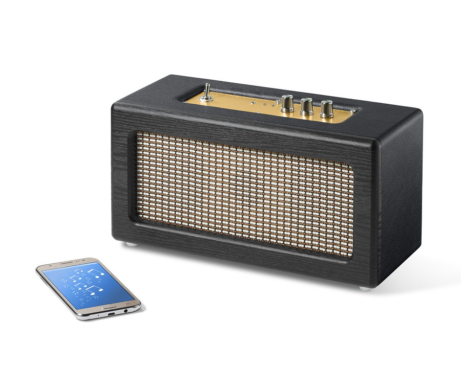 Schwarzer Retro-Bluetooth®-Lautsprecher neben Smartphone.