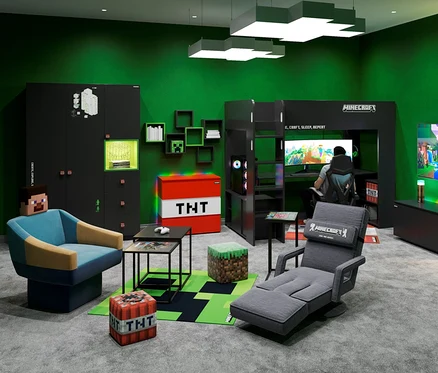 Zimmer mit schwarzen Minecraft-Möbeln, roter TNT-Truhe und einem Mann, der Videospiele spielt.