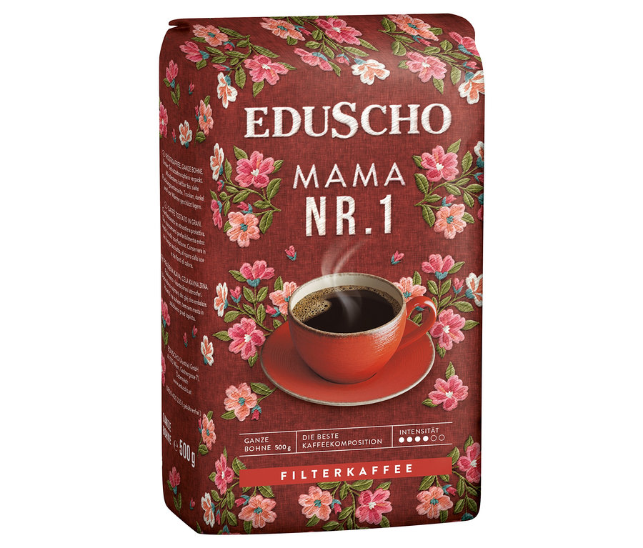 Einzelne Packung EDUSCHO Mama Nr. 1 Ganze Bohne Kaffee, verziert mit Blumenmuster, daneben eine Tasse Kaffee.