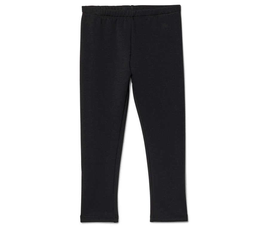 Schwarze Leggings mit elastischem Bund liegen auf einem weißen Hintergrund.