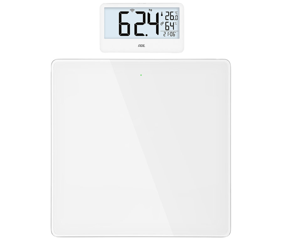 Weiße digitale Personenwaage mit separatem Display, das "62.4 kg", "26.0 °C", "64 %" Luftfeuchtigkeit und "21:06" anzeigt.